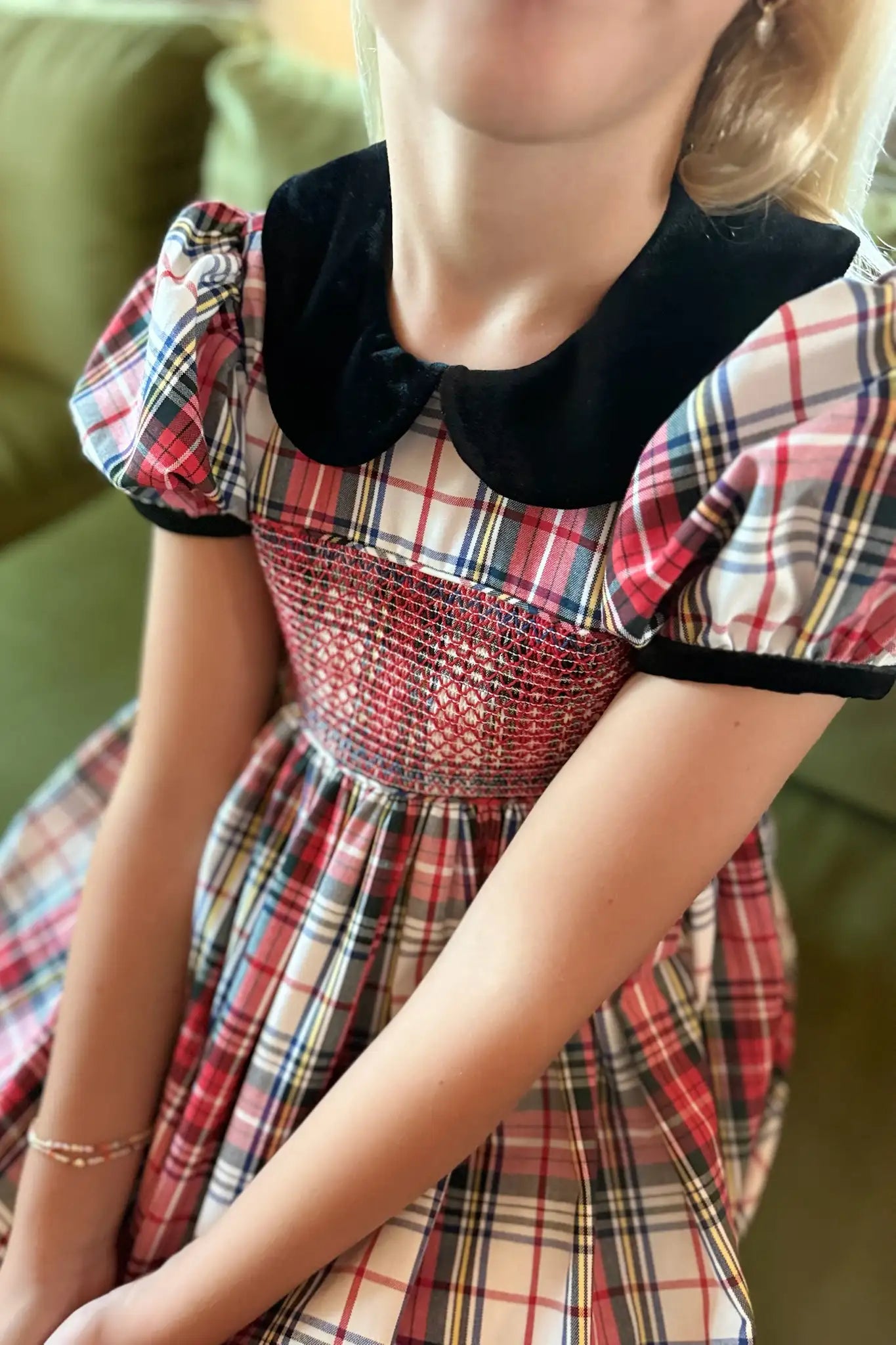 The Joy Kids Dress has a black velvet Peter Pan collar, smocked bodice, and puff short sleeves.