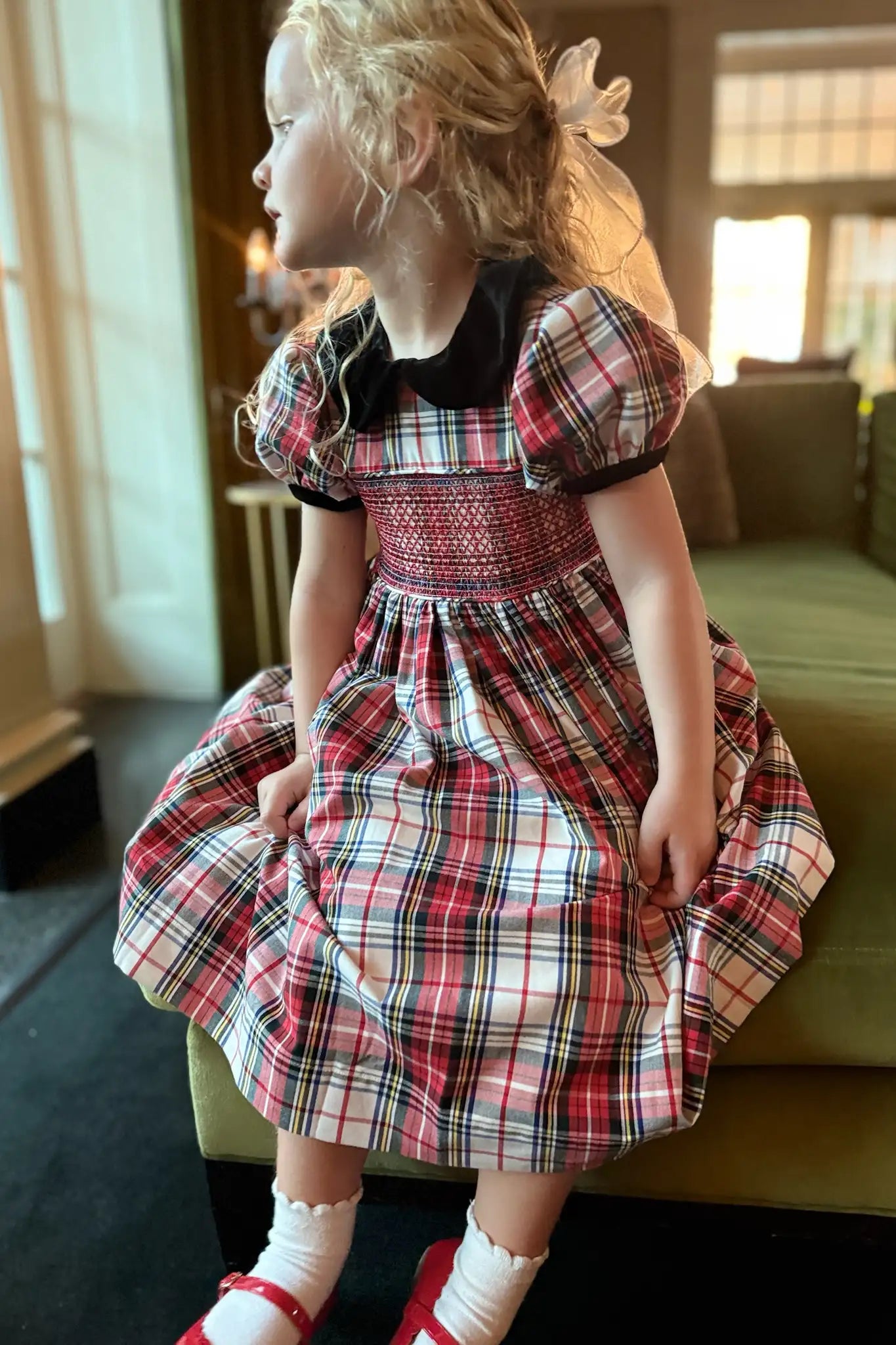 The Joy Kids Dress has a black velvet Peter Pan collar, smocked bodice, and puff short sleeves.