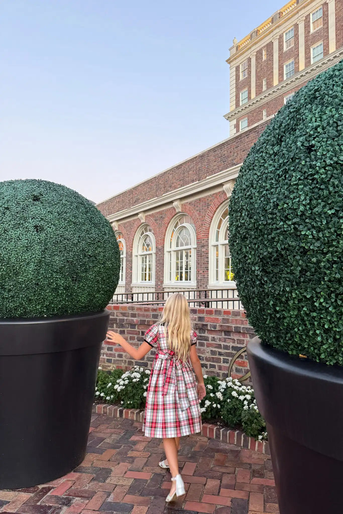 The Joy Kids Dress has a black velvet Peter Pan collar, smocked bodice, and puff short sleeves.