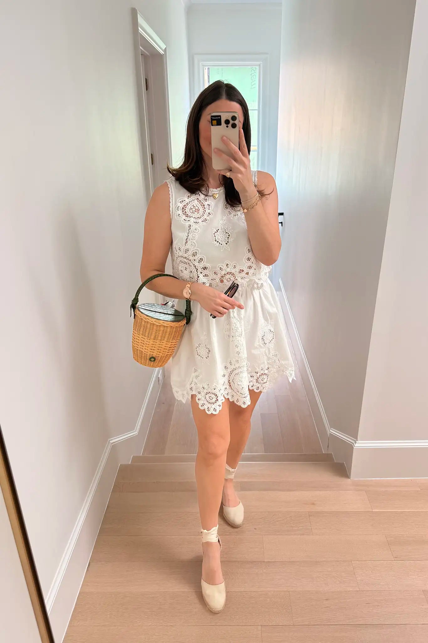 woman wearing white dress taking a selfie