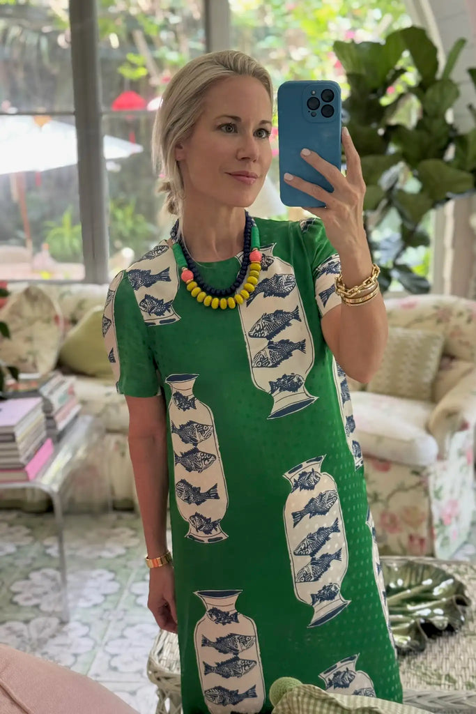 The Valerie Dress has a scoop neckline and a straight bodice in the Herring Green silk blend.