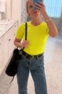 A fitted sweater-knit tee in vibrant neon yellow with a classic crew neckline and short sleeves.