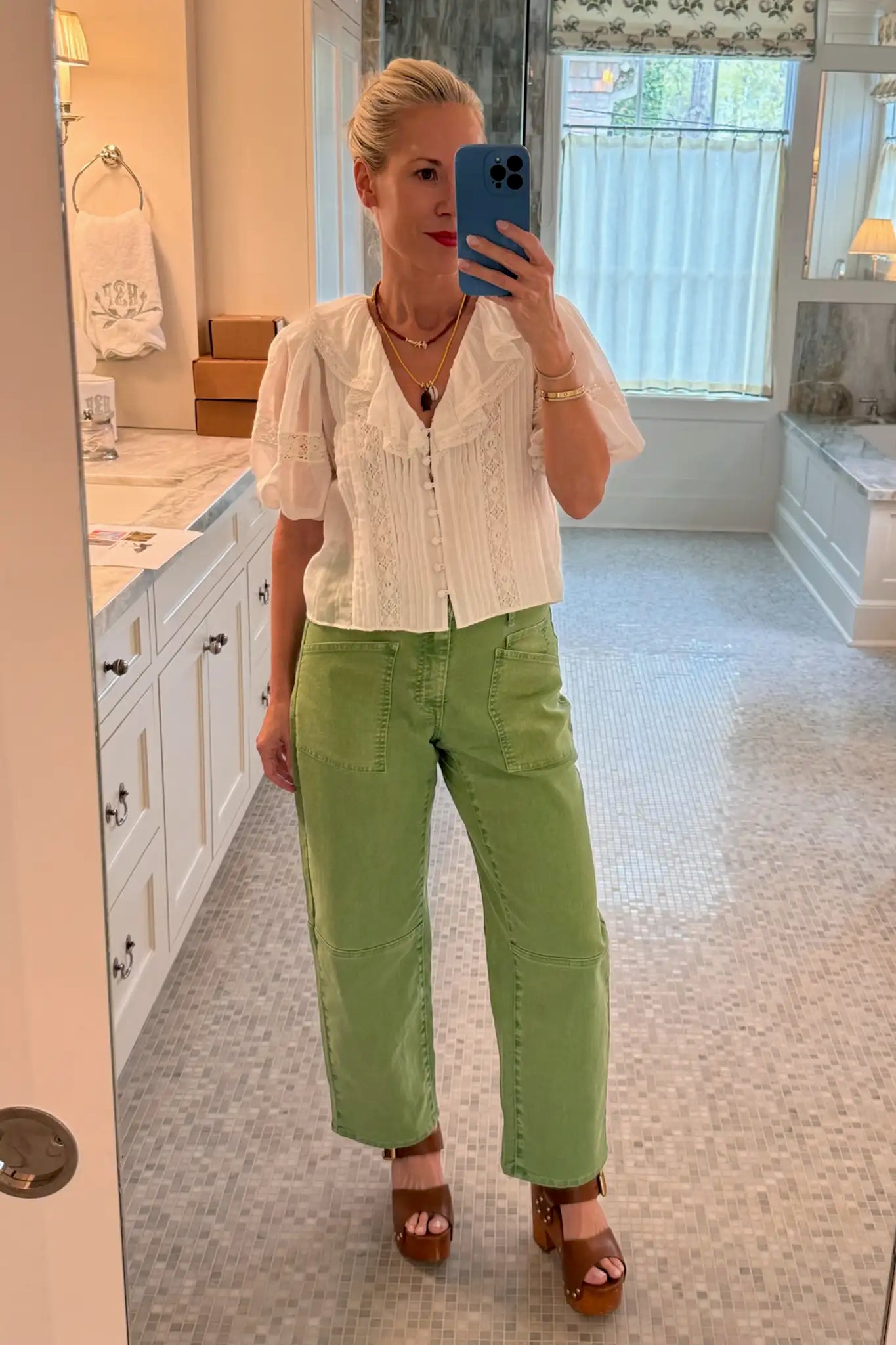Hunter Bell in the Mare Top in white with the Mallory Jeans in Leaf Green Denim.