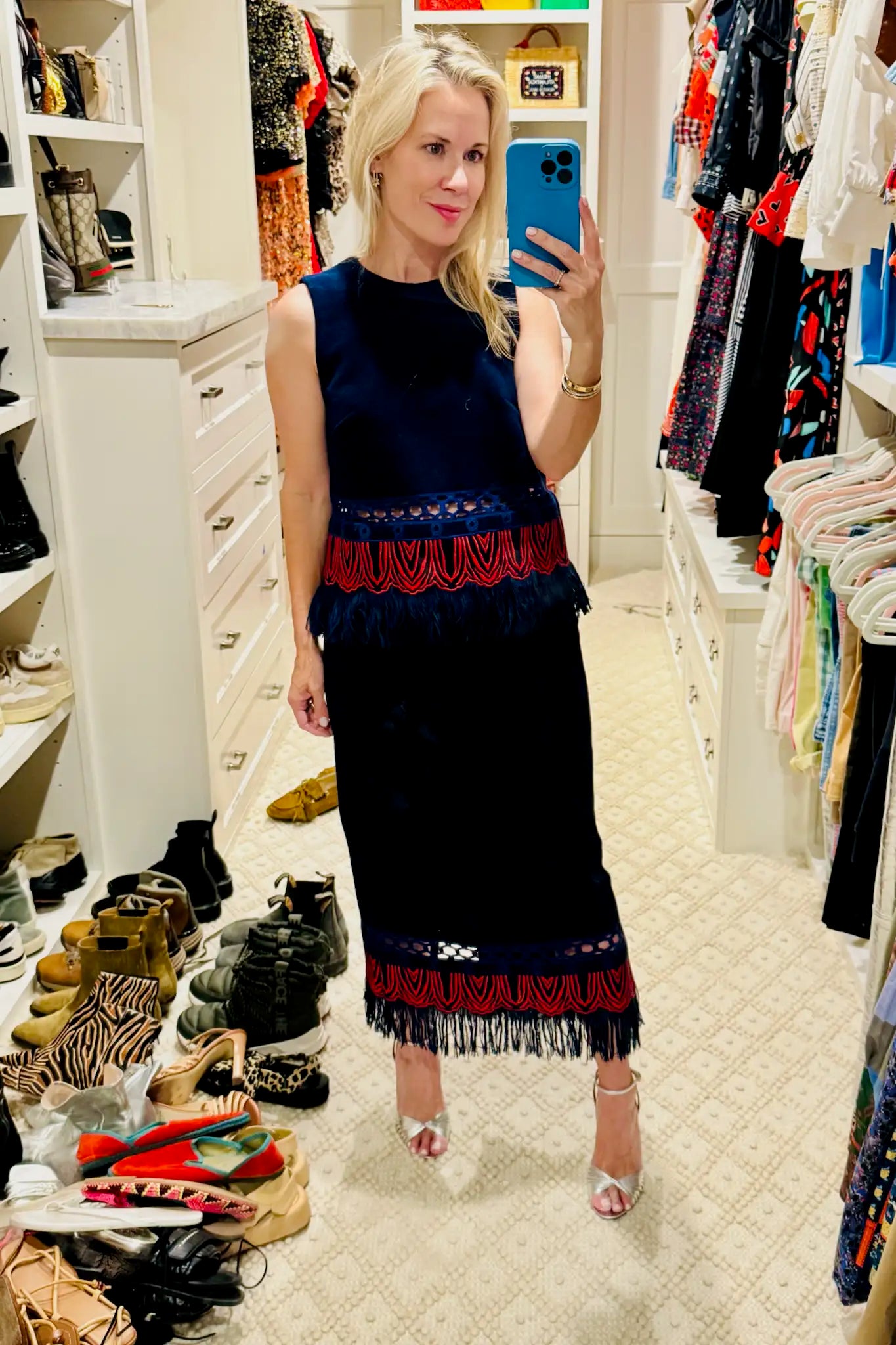 The Astor Top is designed with a crew neckline, button keyhole closure, and sleeveless silhouette.