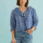 The Imogen Blouse in Bermuda Blooms paired with denim.