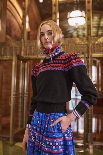 The Jackie fair isle sweater has a ribbed crew neckline and puff sleeves with ribbed cuffs.