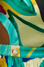 Midi dress in colorful print including pink, green, pink and black with side bodice cut-outs.