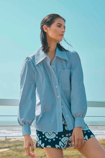 The Jade shirt is a long-sleeve collared shirt with roll-tab sleeves and white stone embellishments.