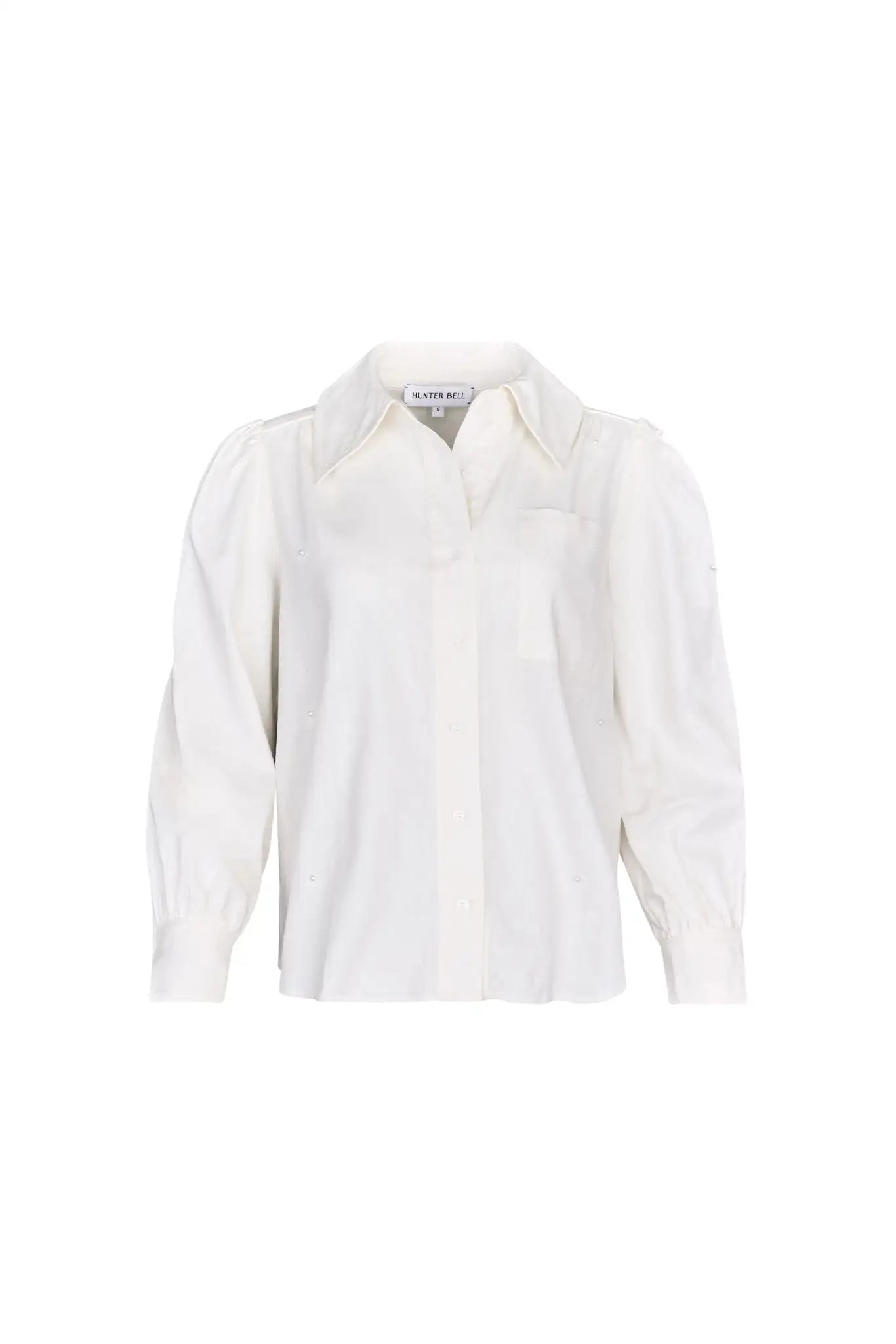 White linen long-sleeve collared shirt with roll-tab sleeves and pearl embellishments.