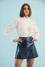 The James Shirt in Ivory paired with the Meeghan Mini Skirt in Navy. 
