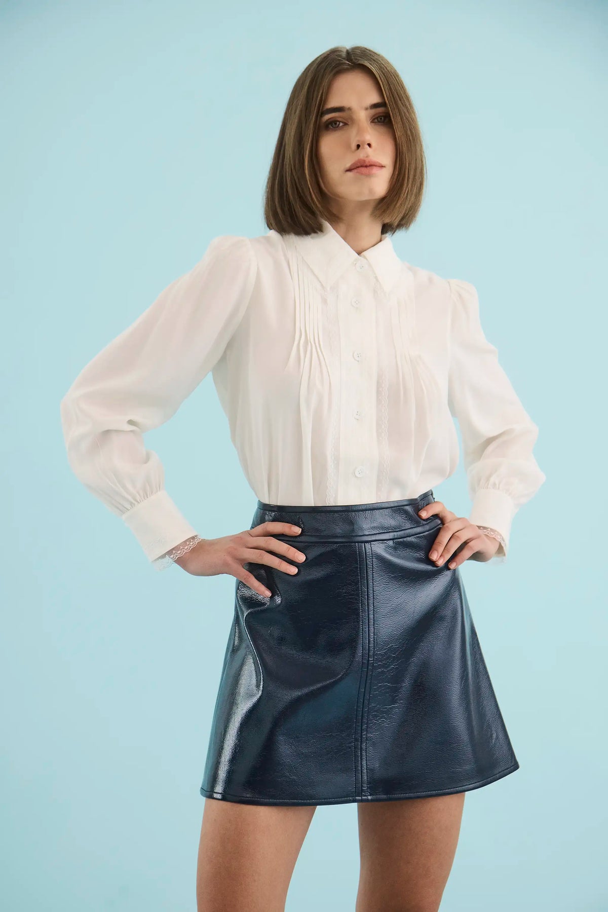 The James Shirt in Ivory paired with the Meeghan Mini Skirt in Navy. 