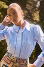 Blue and white gingham button down with a button front placket, shoulder puffing, and pintuck detail