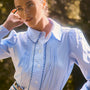 Blue and white gingham button down with a button front placket, shoulder puffing, and pintuck detail