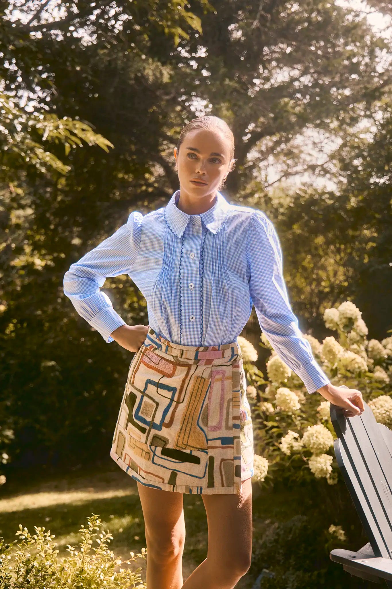 Skirt with a banded waist and sleek wrap silhouette with discreet snap closure.