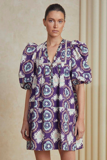 The Jenkins dress is back in a purple London rain print with a contrast color inserted ladder trim. 