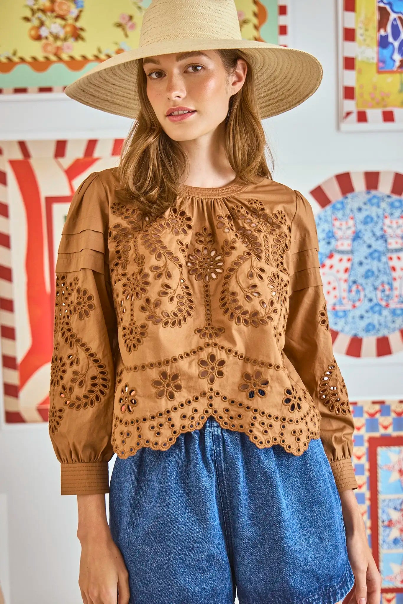 The Jennifer Top in Mocha Embroidered Eyelet has a crew neck and long sleeves with button-cuffs.