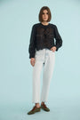 The Jennifer Top in Onyx paired with the Wray Pant in washed blue denim. 