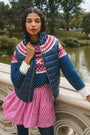 The Brady Vest is a elevated puffer with a collared neckline and a knitted Fair Isle yoke.