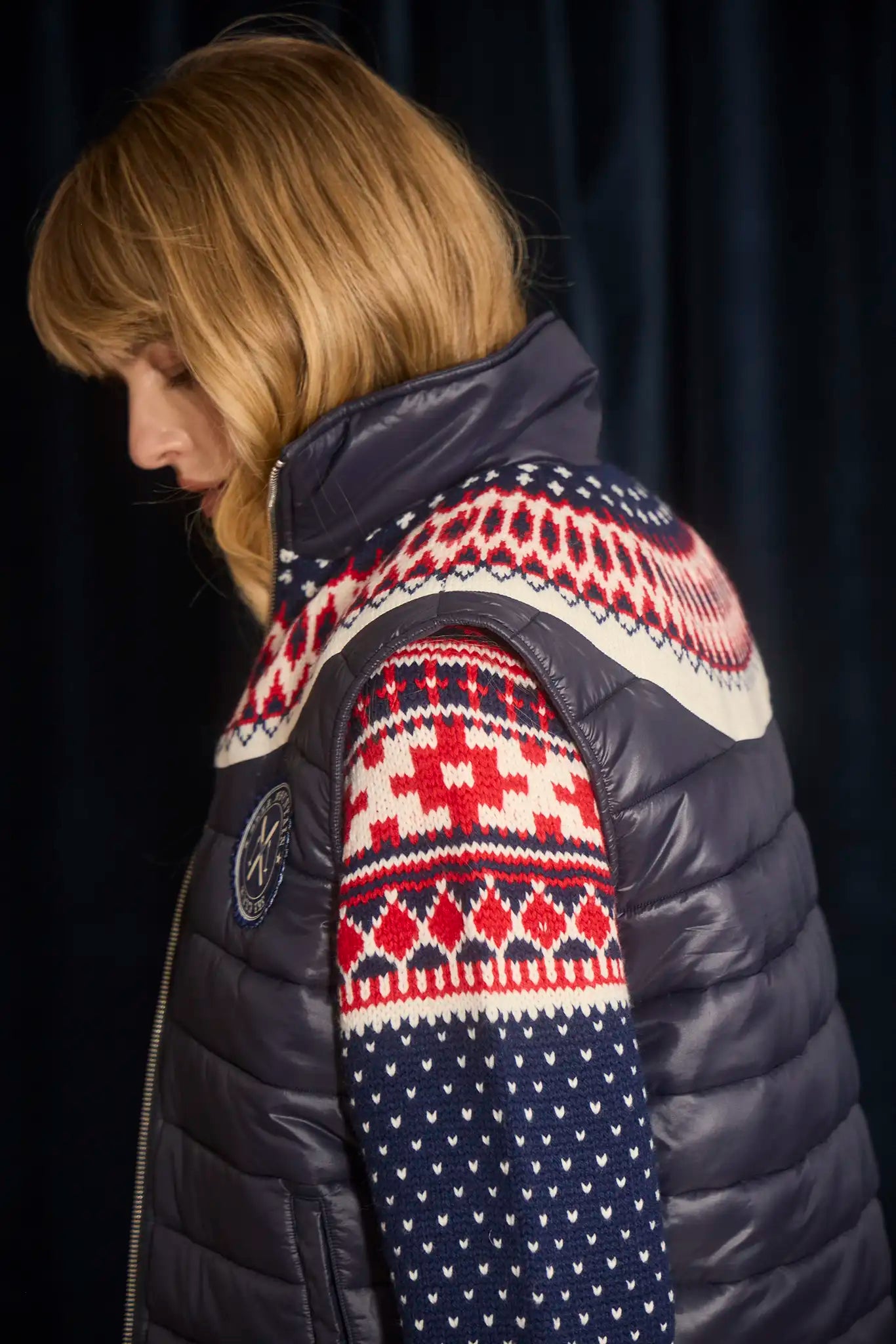 The Brady Vest is a elevated puffer with a collared neckline and a knitted Fair Isle yoke.