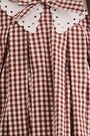 Close up of the Kids Marianne Dress in Cotswold Check Rust. 