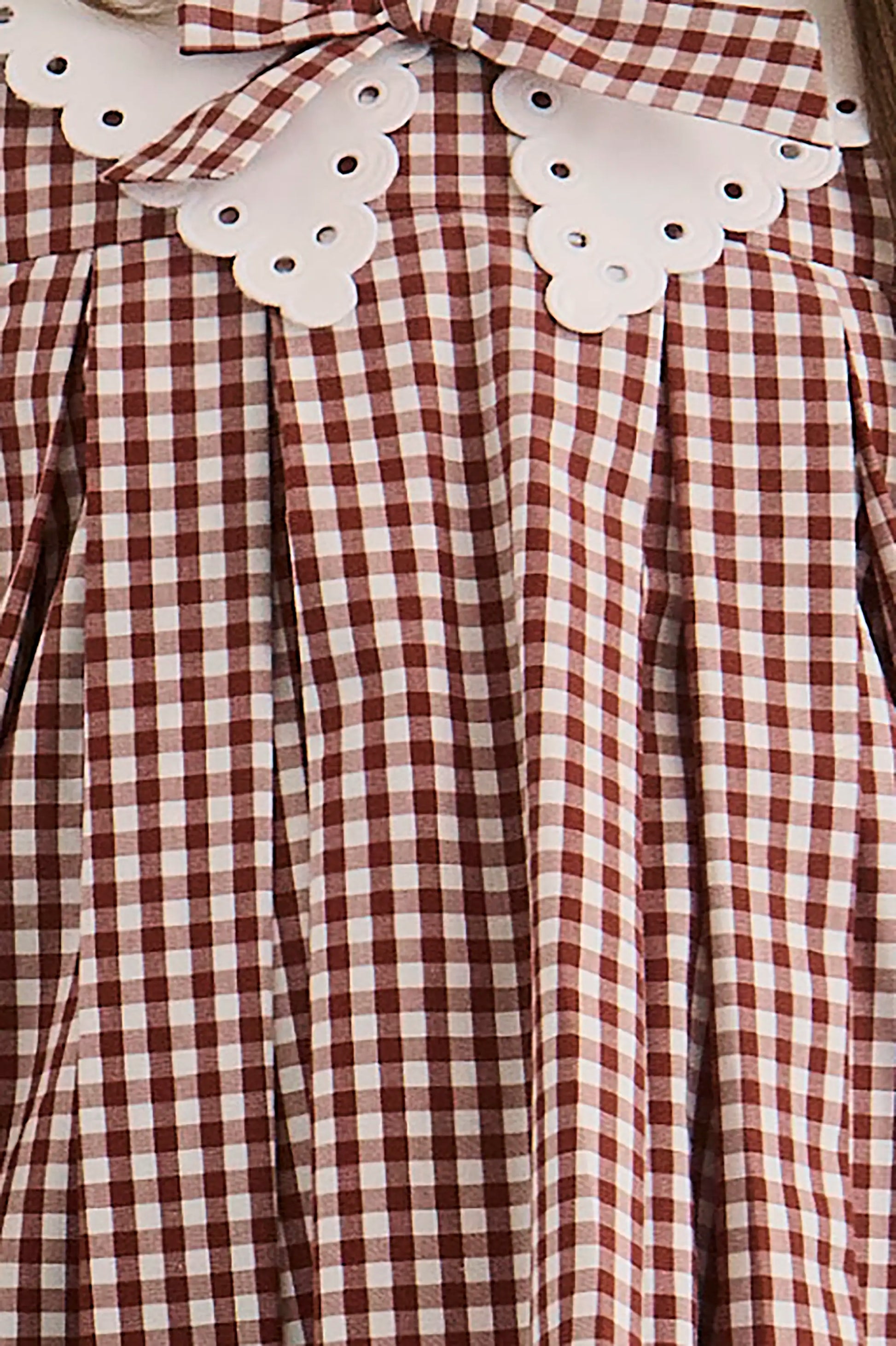 Close up of the Kids Marianne Dress in Cotswold Check Rust. 