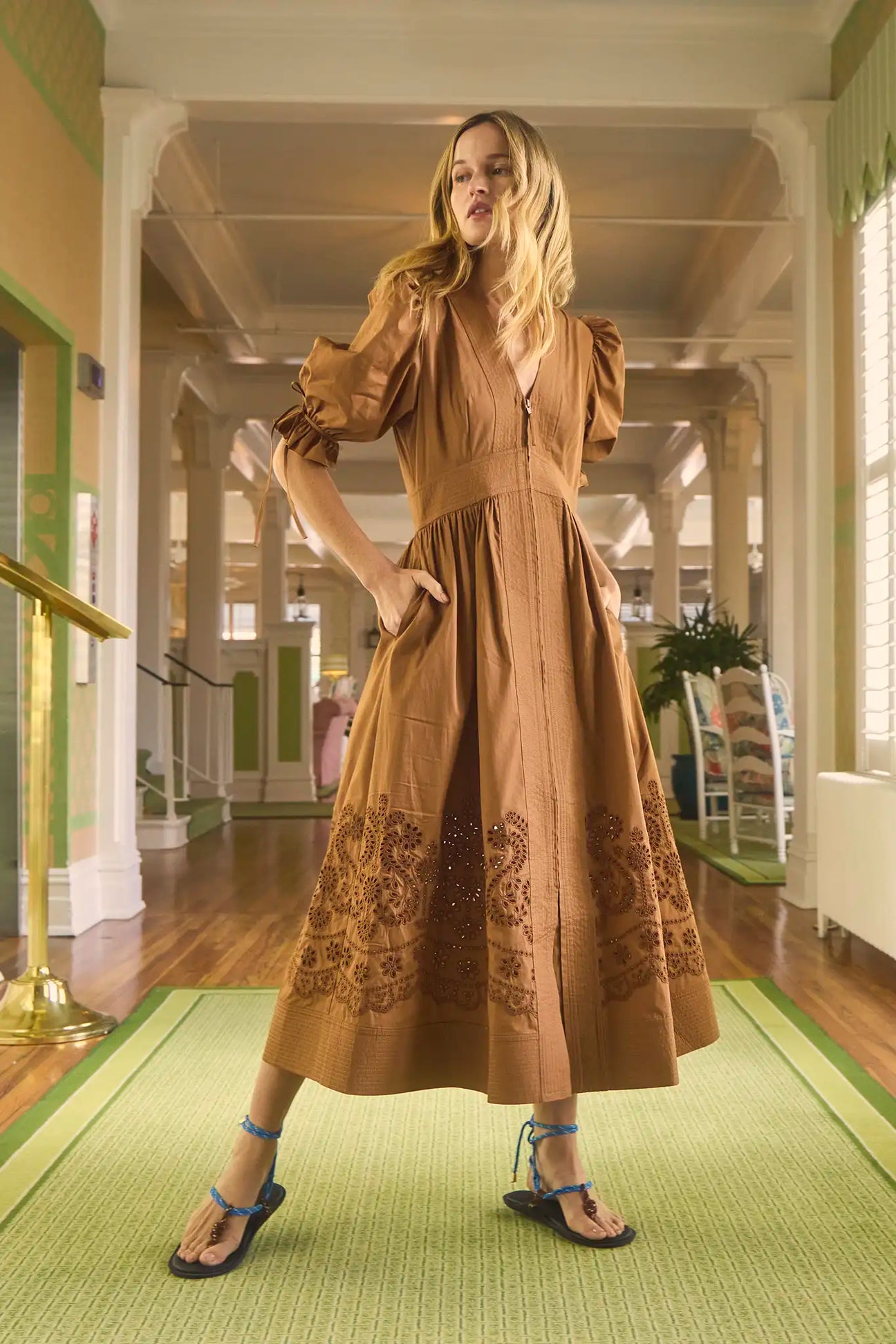 The Kirin Dress has puff sleeves, a V-neckline, a fit-and-flare silhouette and eyelet embroidery.
