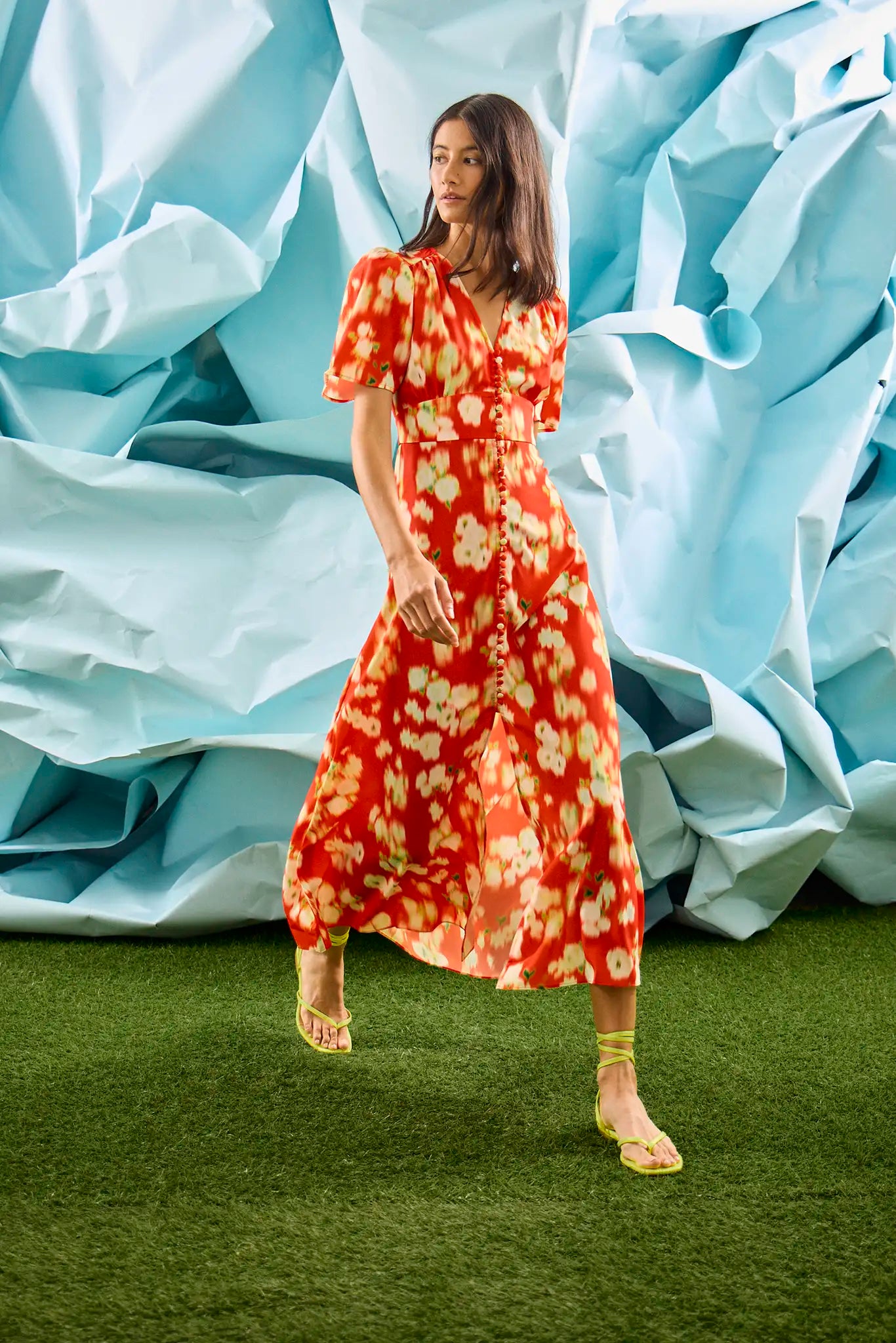 An A-line fitted waist midi dress in an orange and yellow print