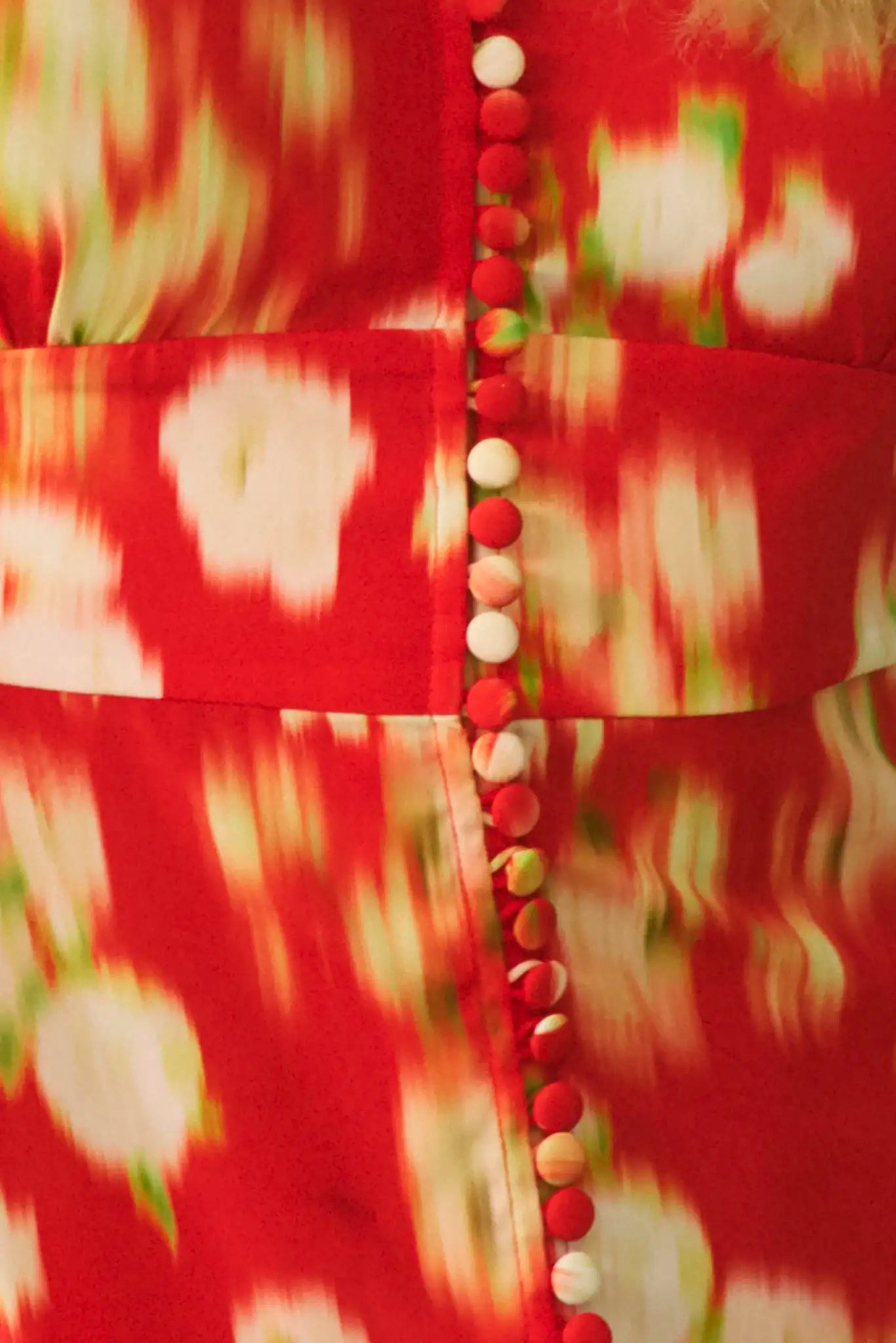 An A-line fitted waist midi dress in an orange and yellow print