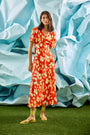 An A-line fitted waist midi dress in an orange and yellow print