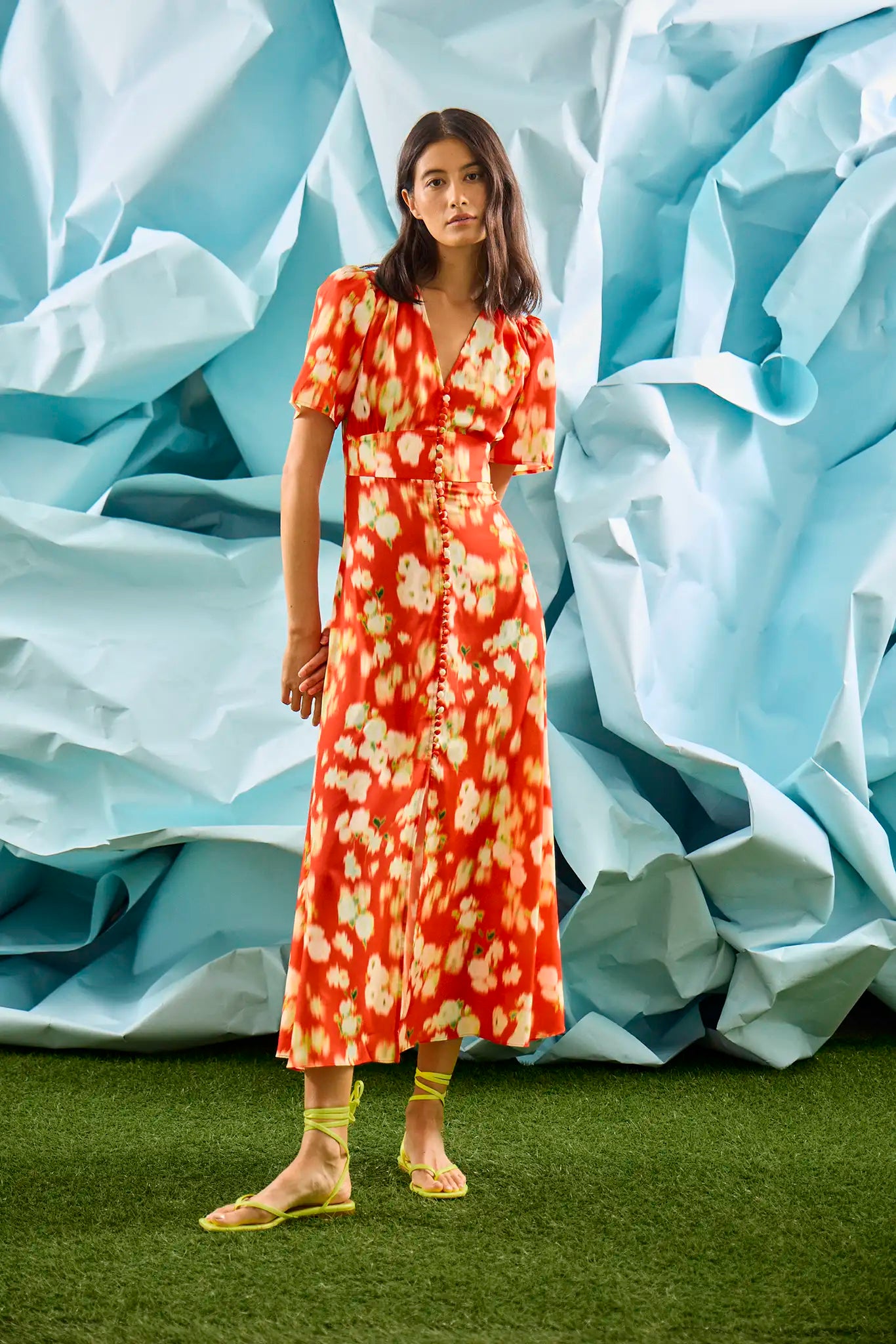 An A-line fitted waist midi dress in an orange and yellow print