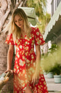 An A-line fitted waist midi dress in an orange and yellow print
