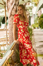 An A-line fitted waist midi dress in an orange and yellow print