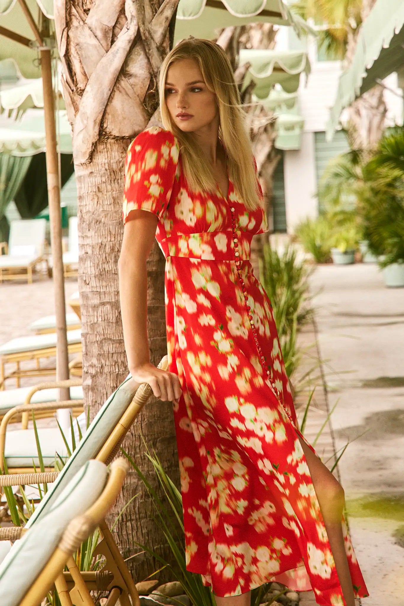 An A-line fitted waist midi dress in an orange and yellow print