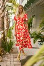 An A-line fitted waist midi dress in an orange and yellow print