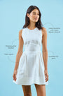 White linen mini dress with structured bustier bodice with call outs.