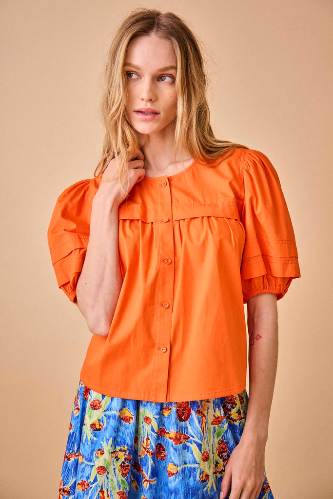 This crew neckline, short bubble sleeve top has shirring at the front and back yoke.