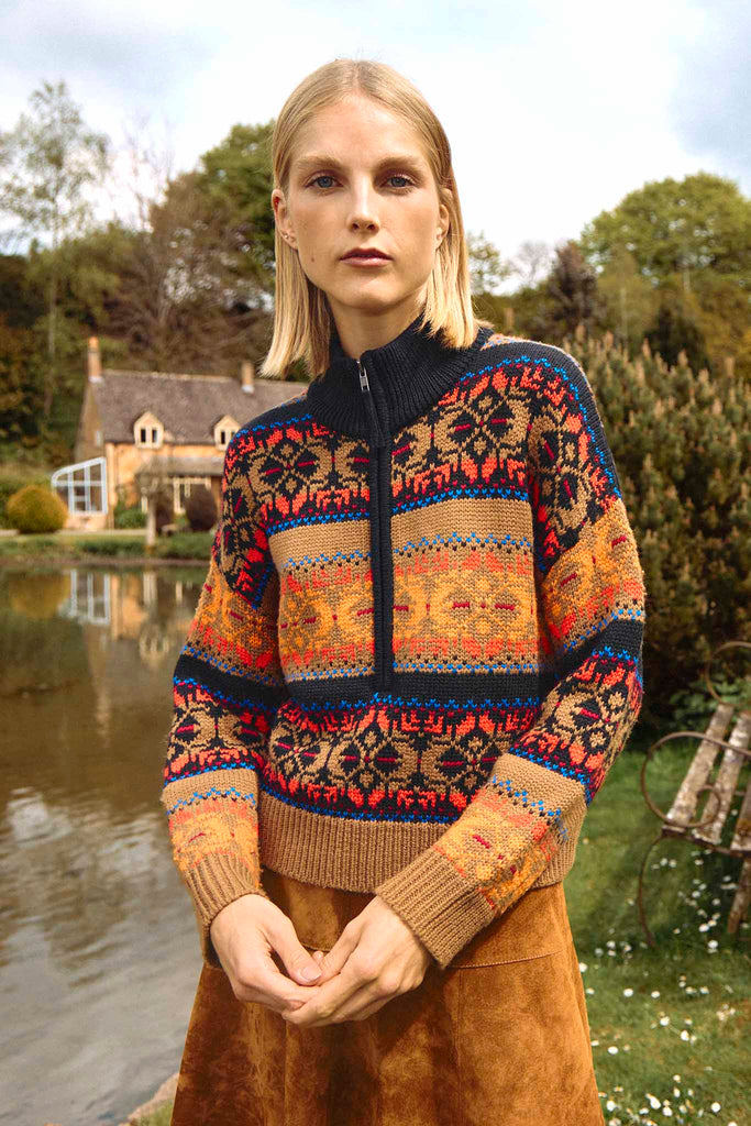 The Lewis fair isle pullover has contrasting ribbed details at the collar, sleeve cuffs, and hem.