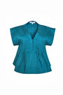 A cropped, boxy top, v-neckline, delicate pintuck detailing and short banded sleeve in petrol green.