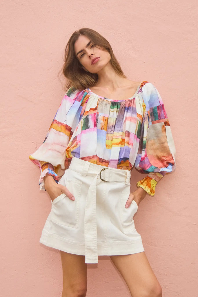 The Madigan Skirt is a fitted mini skirt in stretch twill with front patch pockets and a self belt.