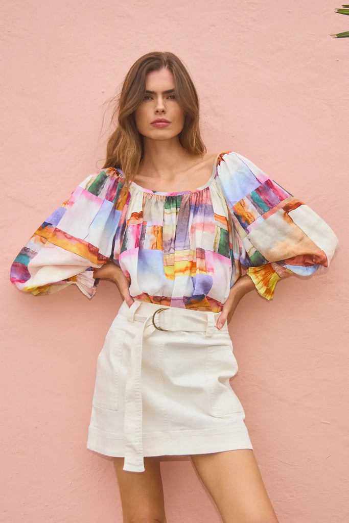 The Lucia Blouse is a scoop neck printed blouse with dramatic long puff sleeves with elastic cuffs.