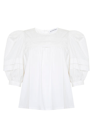 The Lydia Top has a crew neck, puff sleeves, a paneled yoke, topstitching, and button-back keyhole.