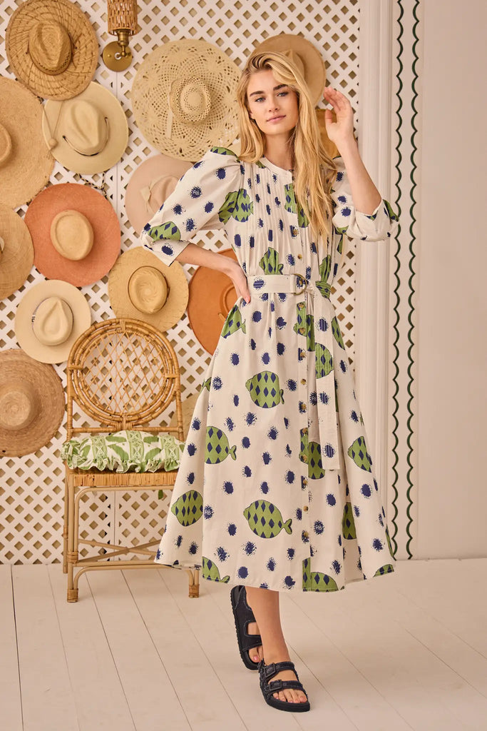 The Lyle Dress has a collarless button front, pintucking, a D-ring belt and three-quarter sleeves.