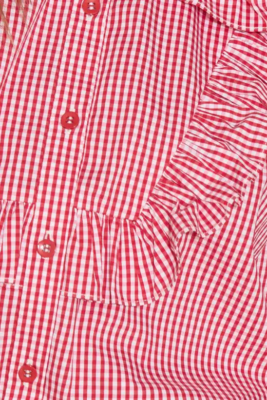 The Mae Top has a collared button front shape, ruffled yokes, and long sleeves with button cuffs. 