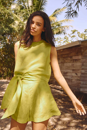 The Ashton high waisted shorts in lime linen have a banded waist with front pleats and an tie sash. 