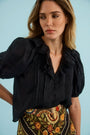 The Mare Top in Onyx paired with the Suki Skirt in Found Heirloom. 