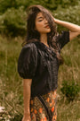 The Mare Top in Onyx paired with the Suki Skirt in Found Heirloom. 