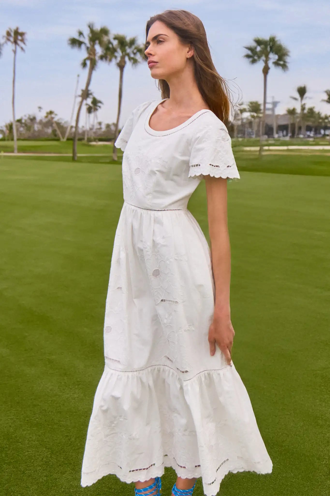 The Marley Dress has a scoop neck, flutter sleeves, an empire waist, and tonal cutout embroidery.