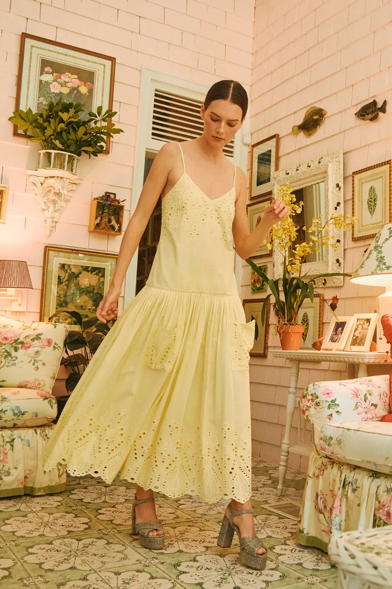 The Martin Dress has eyelet embroidery, a drop waist, shirred skirt, and spaghetti straps.