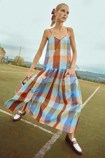 The Martin plaid midi dress has a v-neckline, spaghetti straps, drop waist and a shirred skirt.