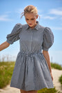The McCauley Dress in Black and White Gingham on model at beach 